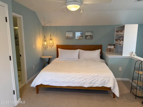 a bedroom with a bed and a lamp with window