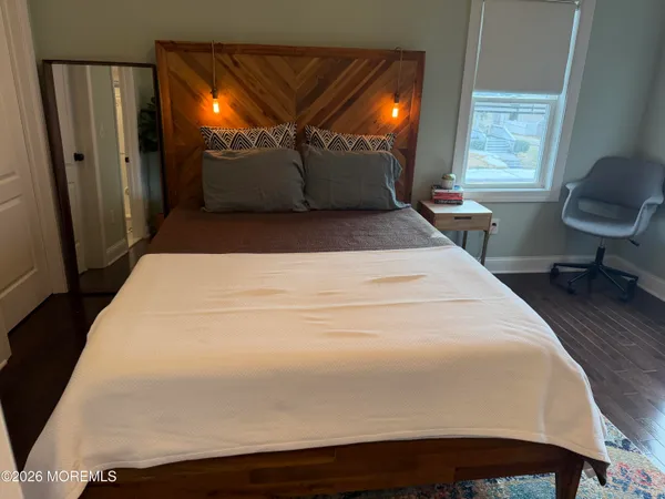 a bed sitting in a bedroom next to a window