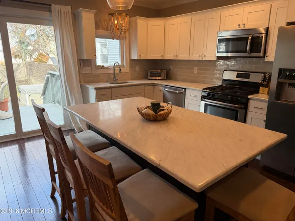 a kitchen with a stove a sink and a microwave