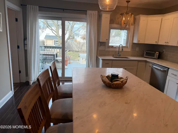 a kitchen with stainless steel appliances a sink a stove and a window