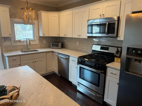 a kitchen with a sink stove and microwave
