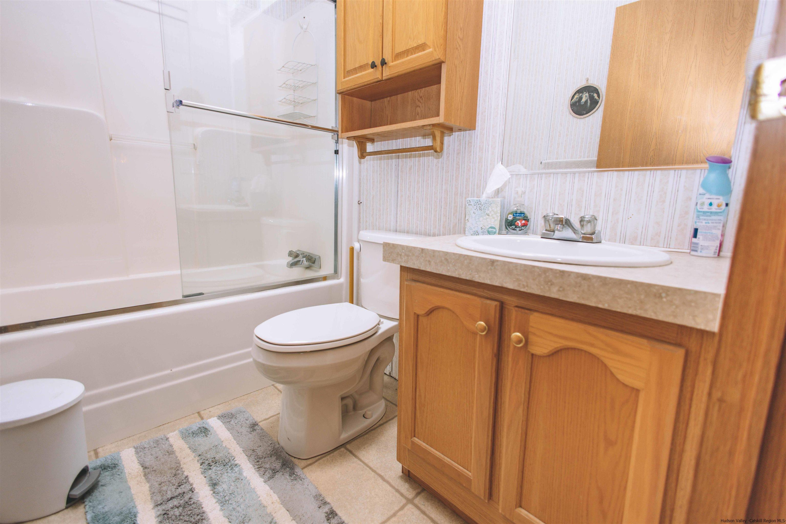 186 Patch Road Saugerties, NY 12477 - Photo 18 of 34 a bathroom with a granite countertop toilet sink and a mirror