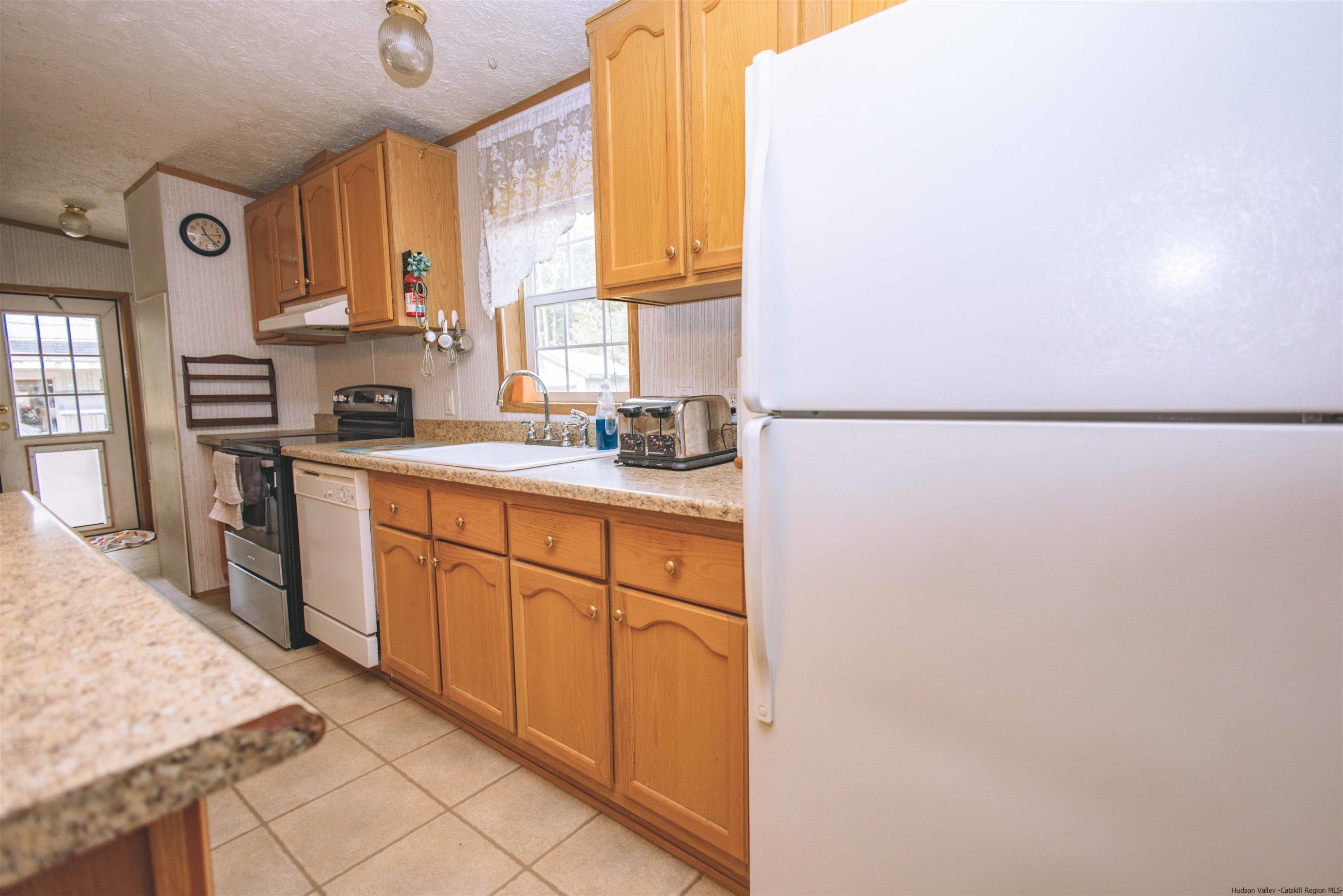 186 Patch Road Saugerties, NY 12477 - Photo 8 of 34 a kitchen with a refrigerator sink and cabinets
