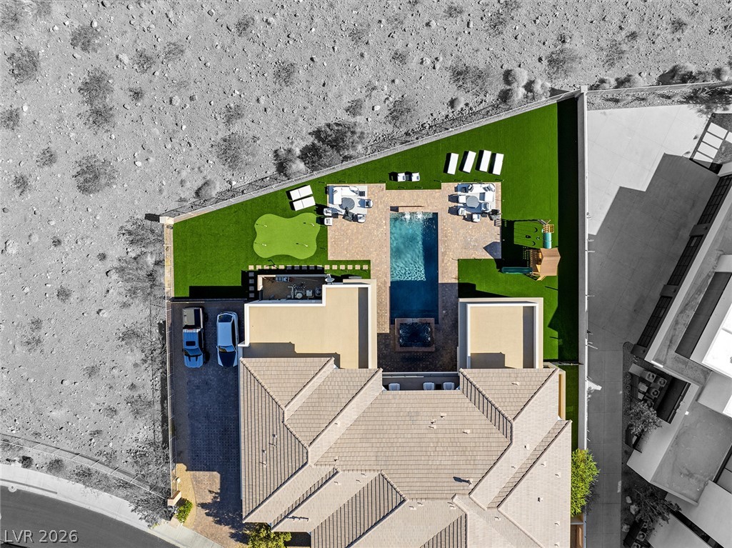 5 Crystal Tree Pass Henderson, NV 89052 - Photo 61 of 67 An aerial perspective showcases a home with a sprawling backyard featuring a swimming pool, spa, and miniature golf putting green.