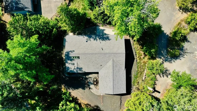 an aerial view of a house with a yard and garden
