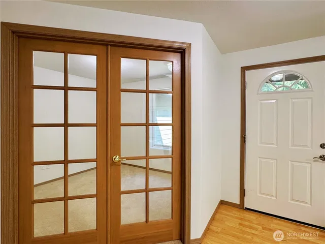 a view of front door with wooden floor