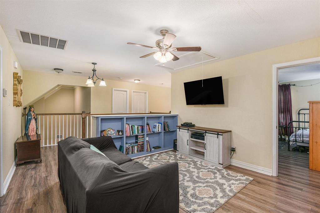 203 Saddle Ridge Court Springtown, TX 76082 - Photo 18 of 34 a living room with furniture and a flat screen tv