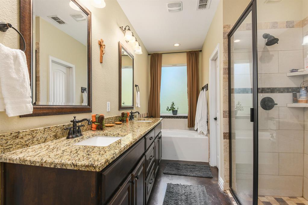 203 Saddle Ridge Court Springtown, TX 76082 - Photo 21 of 34 a bathroom with a granite countertop sink and a mirror