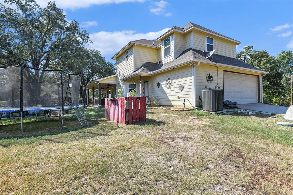203 Saddle Ridge Court Springtown, TX 76082 - Photo 31 of 34 a front view of house with yard and trees