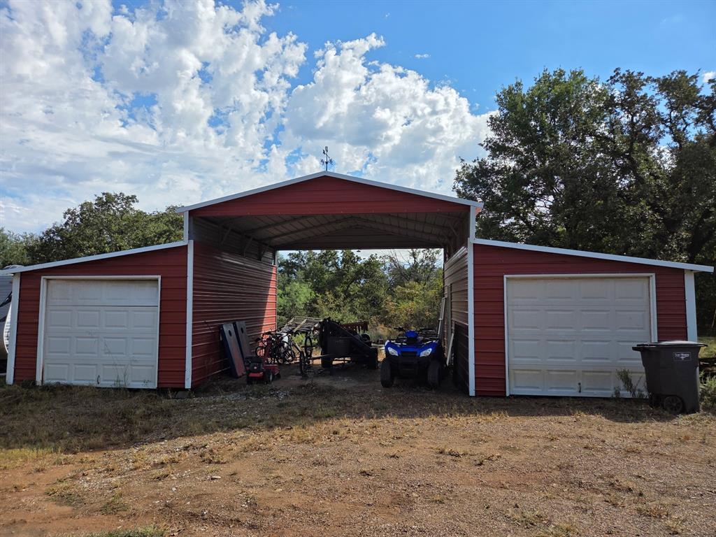 203 Saddle Ridge Court Springtown, TX 76082 - Photo 32 of 34 a couple of table and chairs in the back yard of the house