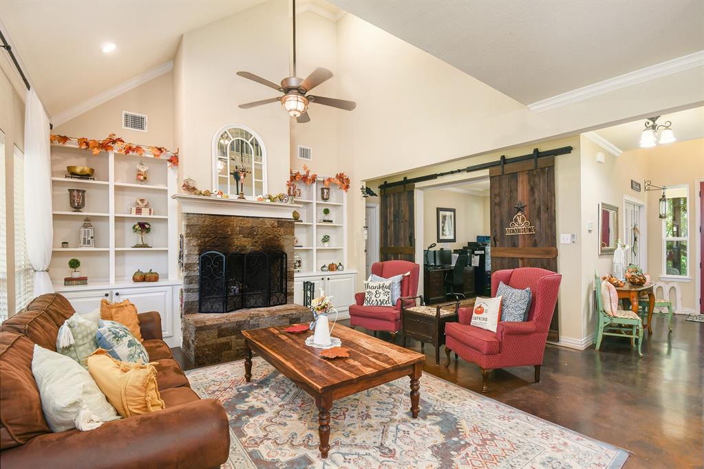 203 Saddle Ridge Court Springtown, TX 76082 - Photo 4 of 34 a living room with furniture fireplace and wooden floor
