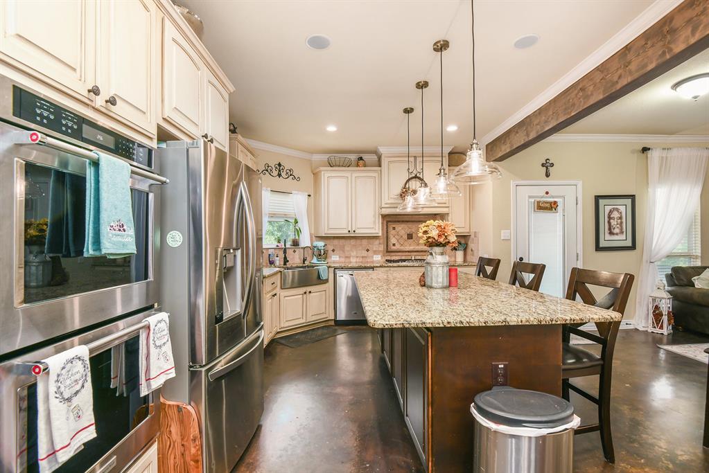 203 Saddle Ridge Court Springtown, TX 76082 - Photo 10 of 34 a kitchen with a table chairs and refrigerator
