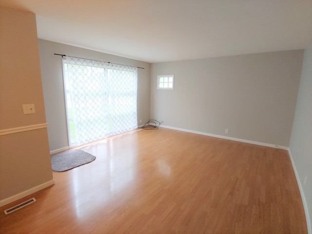 13 Wren Road Carpentersville, IL 60110 - Photo 3 of 11 a view of an empty room with wooden floor and a window