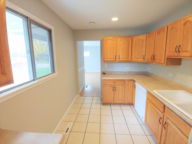 13 Wren Road Carpentersville, IL 60110 - Photo 5 of 11 a kitchen with a sink a stove cabinets and a window