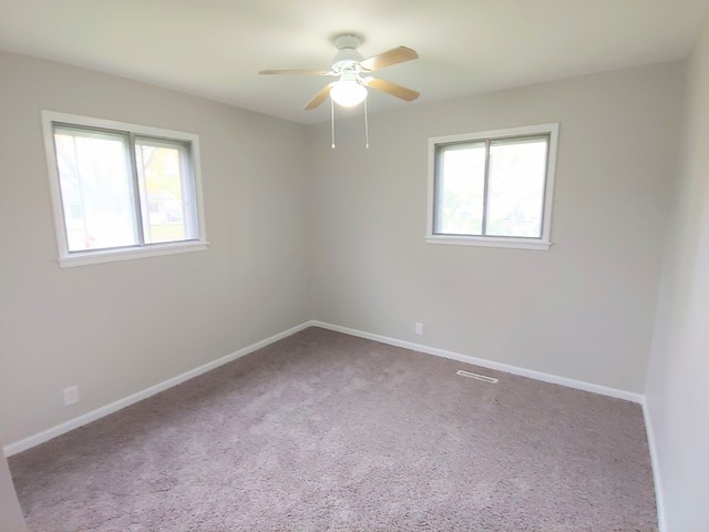 13 Wren Road Carpentersville, IL 60110 - Photo 8 of 11 an empty room with a window and a fan
