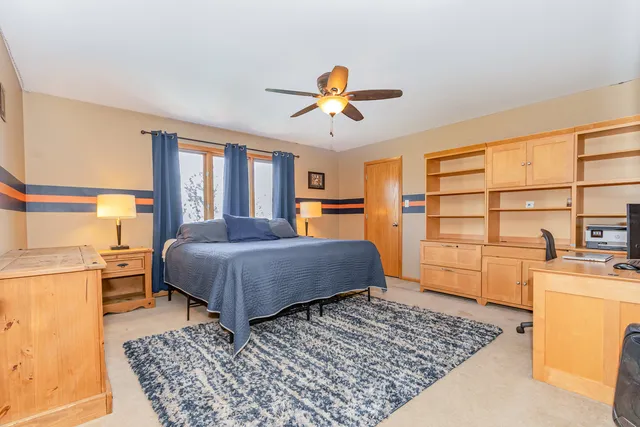 a bedroom with a bed dresser and a window