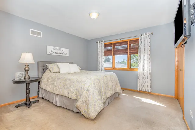 a spacious bedroom with a bed and a table