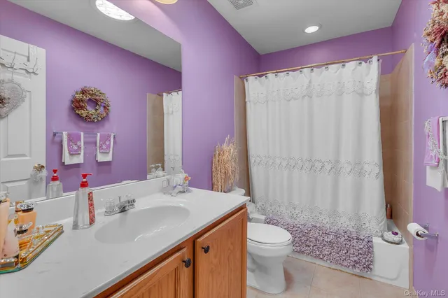 a bathroom with a sink vanity mirror and toilet