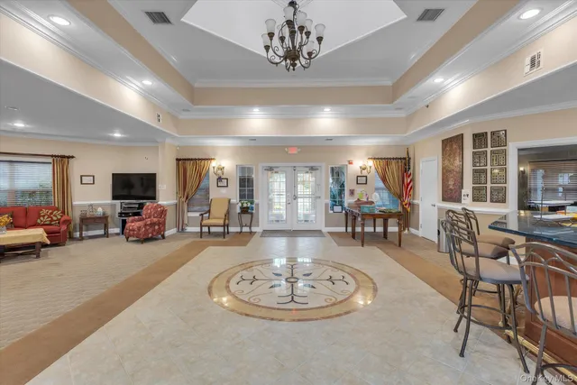a view of a livingroom with furniture a fireplace and wooden floor