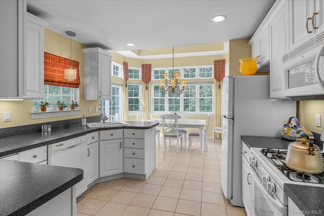 a kitchen with granite countertop a sink stove and cabinets