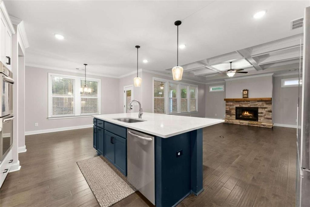 876 Sweetgrass Drive Demorest, GA 30535 - Photo 13 of 56 a kitchen with kitchen island a sink stove and wooden floor