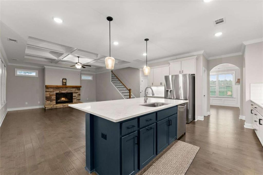 876 Sweetgrass Drive Demorest, GA 30535 - Photo 14 of 56 a kitchen with a sink a refrigerator and chairs