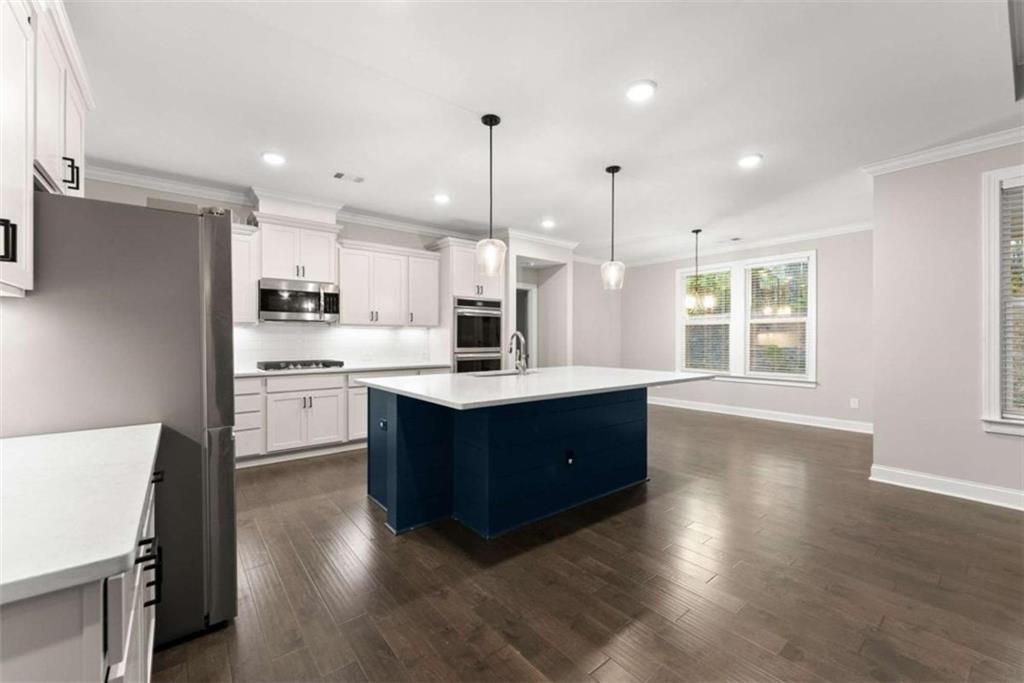 876 Sweetgrass Drive Demorest, GA 30535 - Photo 17 of 56 a kitchen with wooden floors and white cabinets