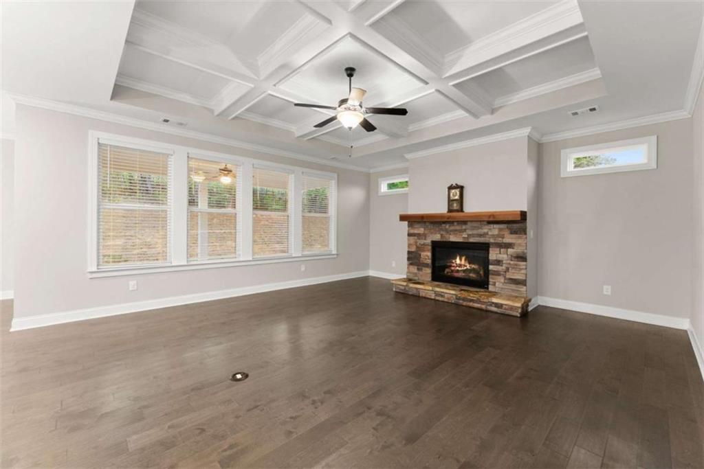 876 Sweetgrass Drive Demorest, GA 30535 - Photo 18 of 56 an empty room with windows fireplace and a ceiling fan