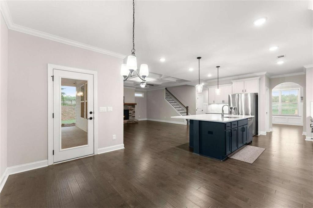 876 Sweetgrass Drive Demorest, GA 30535 - Photo 22 of 56 a large kitchen with a lot of counter space and a chandelier