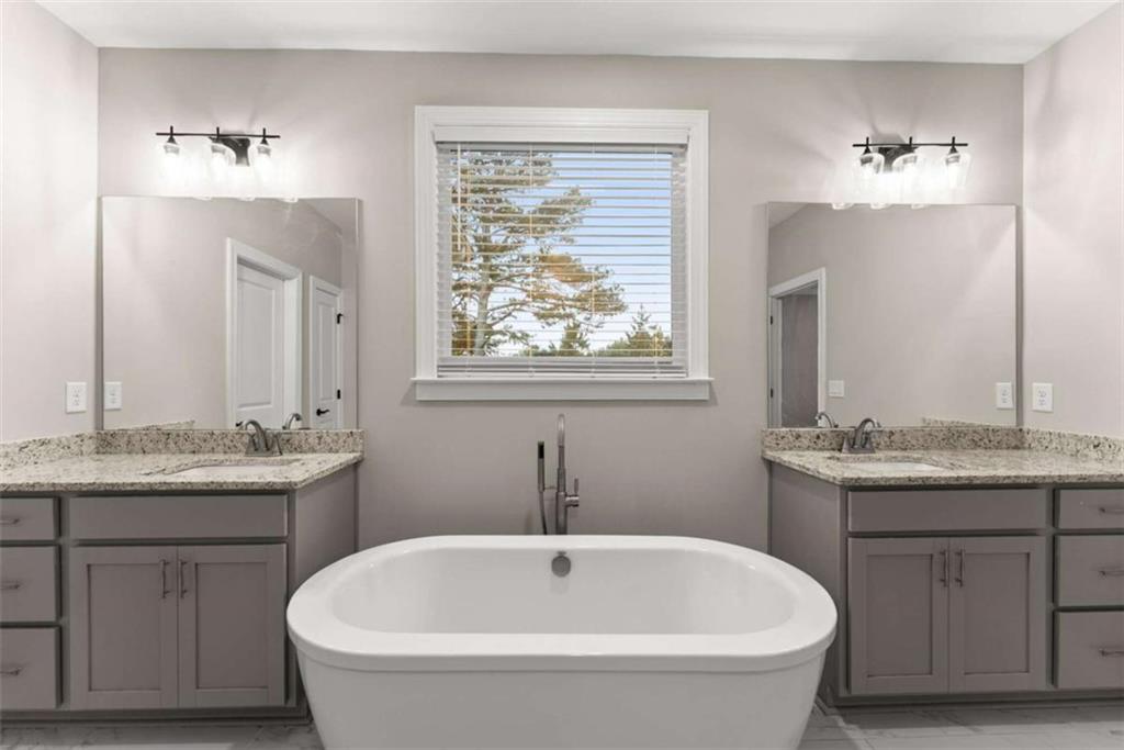 876 Sweetgrass Drive Demorest, GA 30535 - Photo 30 of 56 a bathroom with a granite countertop sink a toilet and a mirror