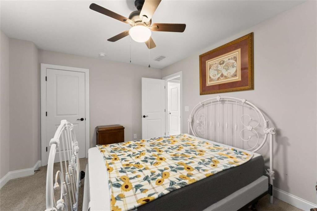 876 Sweetgrass Drive Demorest, GA 30535 - Photo 38 of 56 a bedroom with a bed and a chandelier