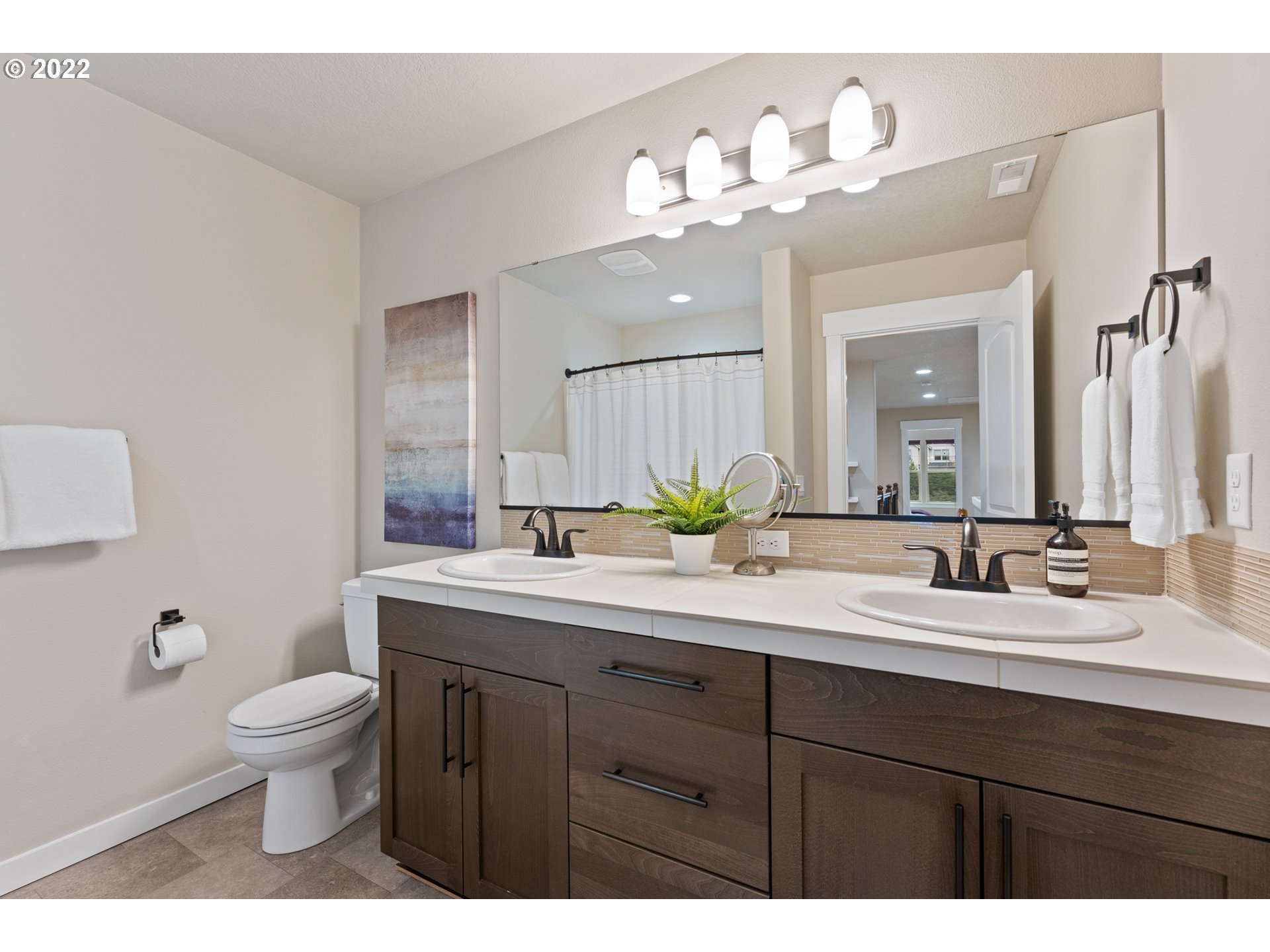 14026 Southwest 118th Court Tigard, OR 97224 - Photo 16 of 31 a bathroom with a double vanity sink mirror and toilet