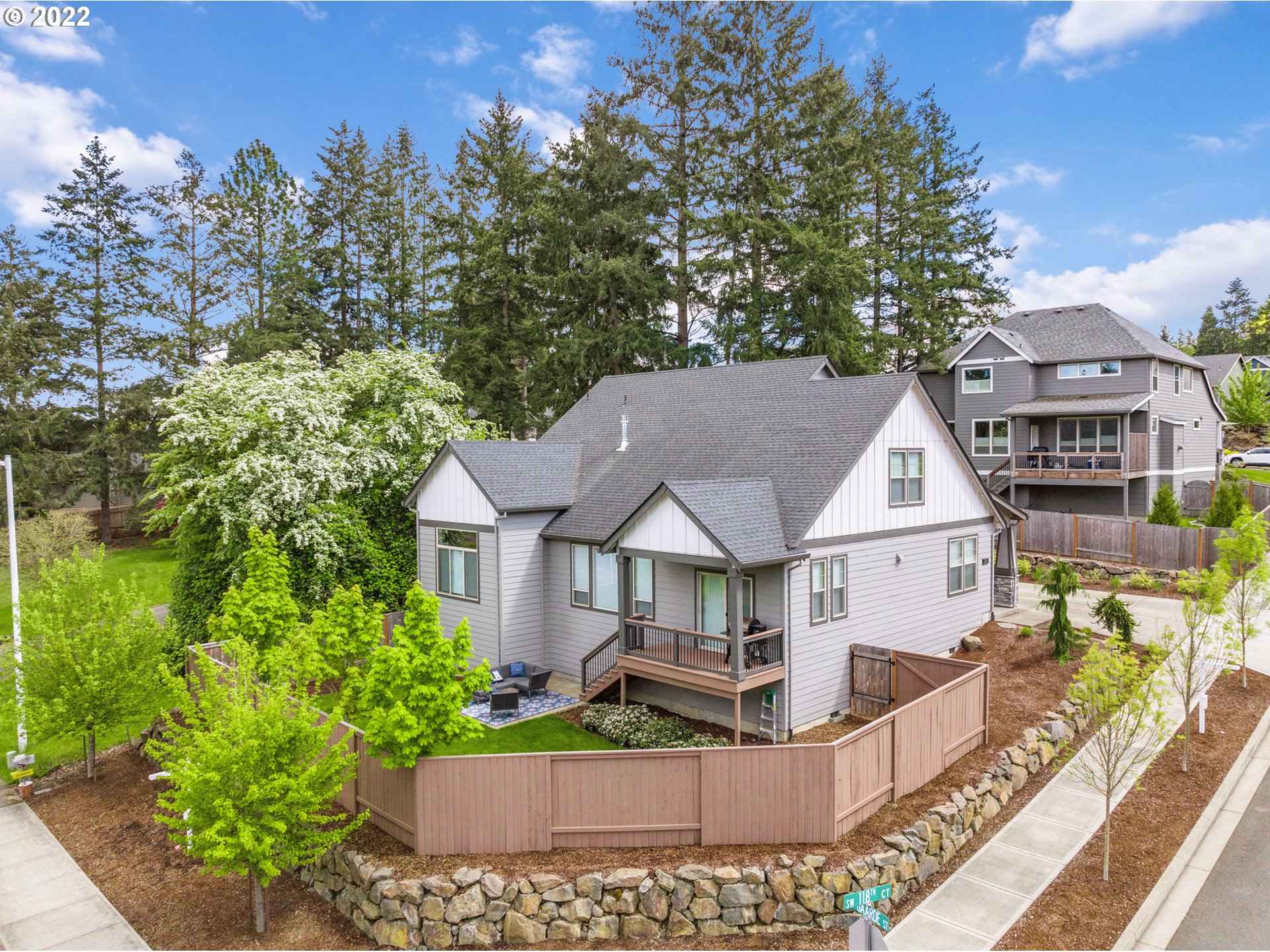 14026 Southwest 118th Court Tigard, OR 97224 - Photo 2 of 31 a view of a white house next to a yard with plants and trees