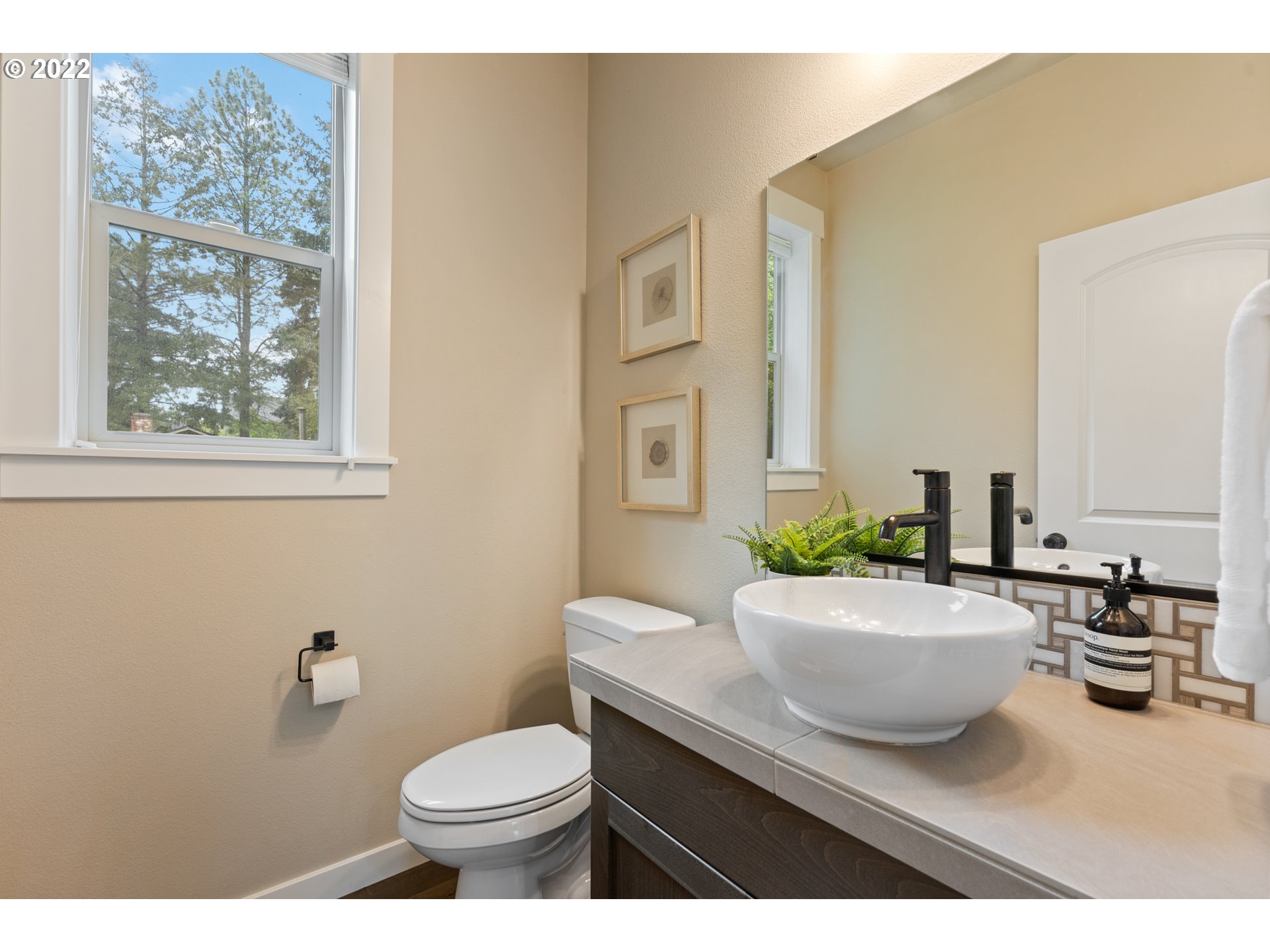 14026 Southwest 118th Court Tigard, OR 97224 - Photo 24 of 31 a bathroom with a toilet a sink and mirror