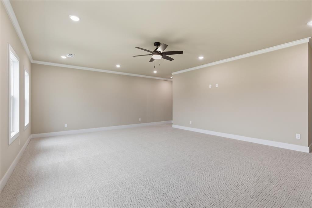 702 Anne Road Van Alstyne, TX 75495 - Photo 22 of 27 Expansive room featuring light-toned carpeting, ample recessed lighting, a ceiling fan, and multiple windows