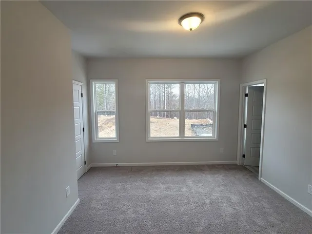 an empty room with a empty space and windows