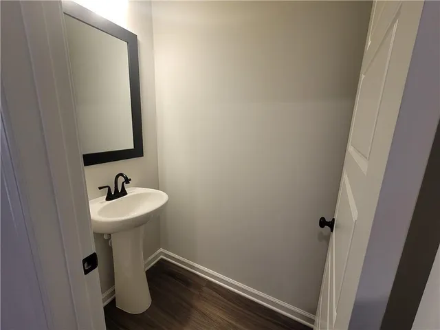 a bathroom with a sink mirror and toilet