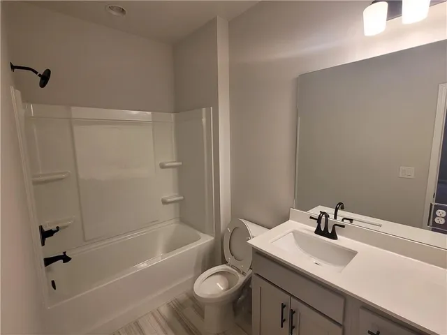a bathroom with a sink a toilet and a bathtub
