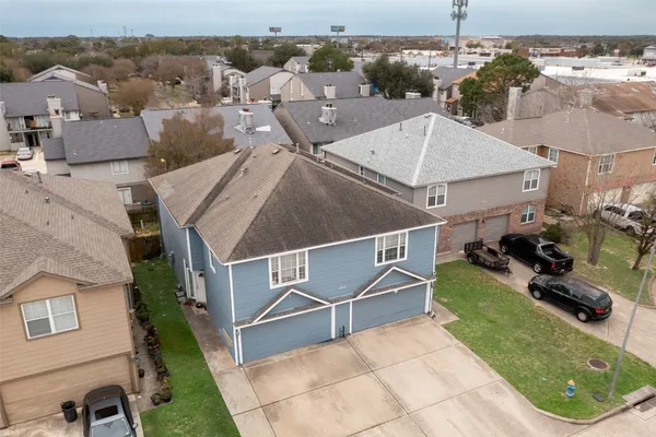 an aerial view of a house with a yard