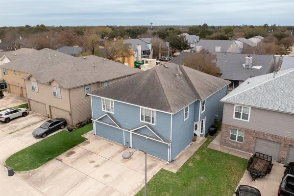 an aerial view of a house with a yard