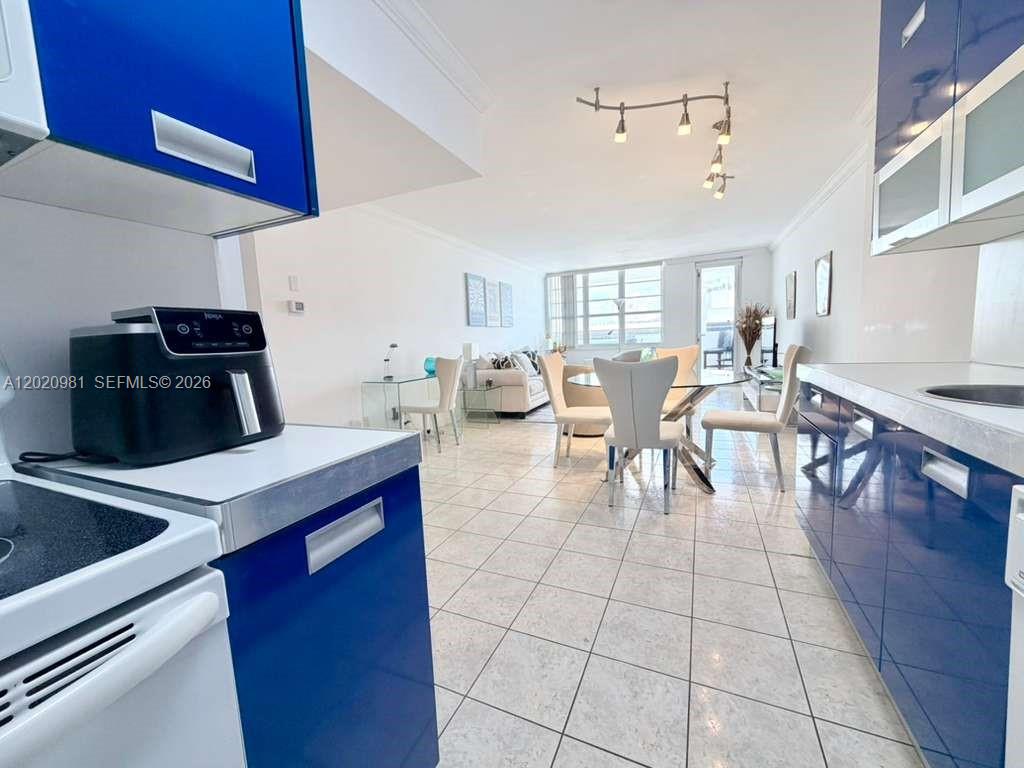 100 Lincoln Road, Unit 1423 Miami Beach, FL 33139 - Photo 6 of 17 a dining hall with a dining table chairs and white cabinets