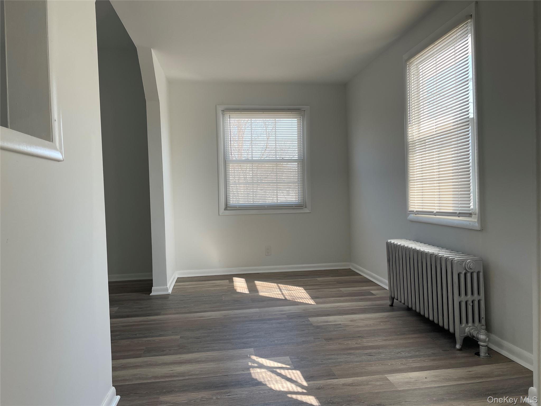 502 West Nyack Road, Unit 1 West Nyack, NY 10994 - Photo 11 of 12 an empty room with wooden floor and windows