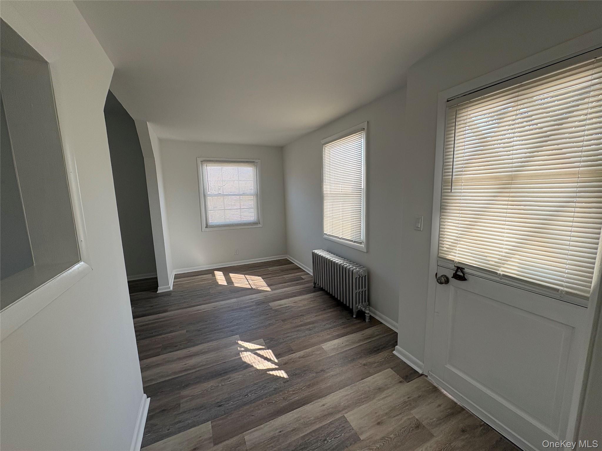 502 West Nyack Road, Unit 1 West Nyack, NY 10994 - Photo 12 of 12 a view of an empty room with wooden floor and a window