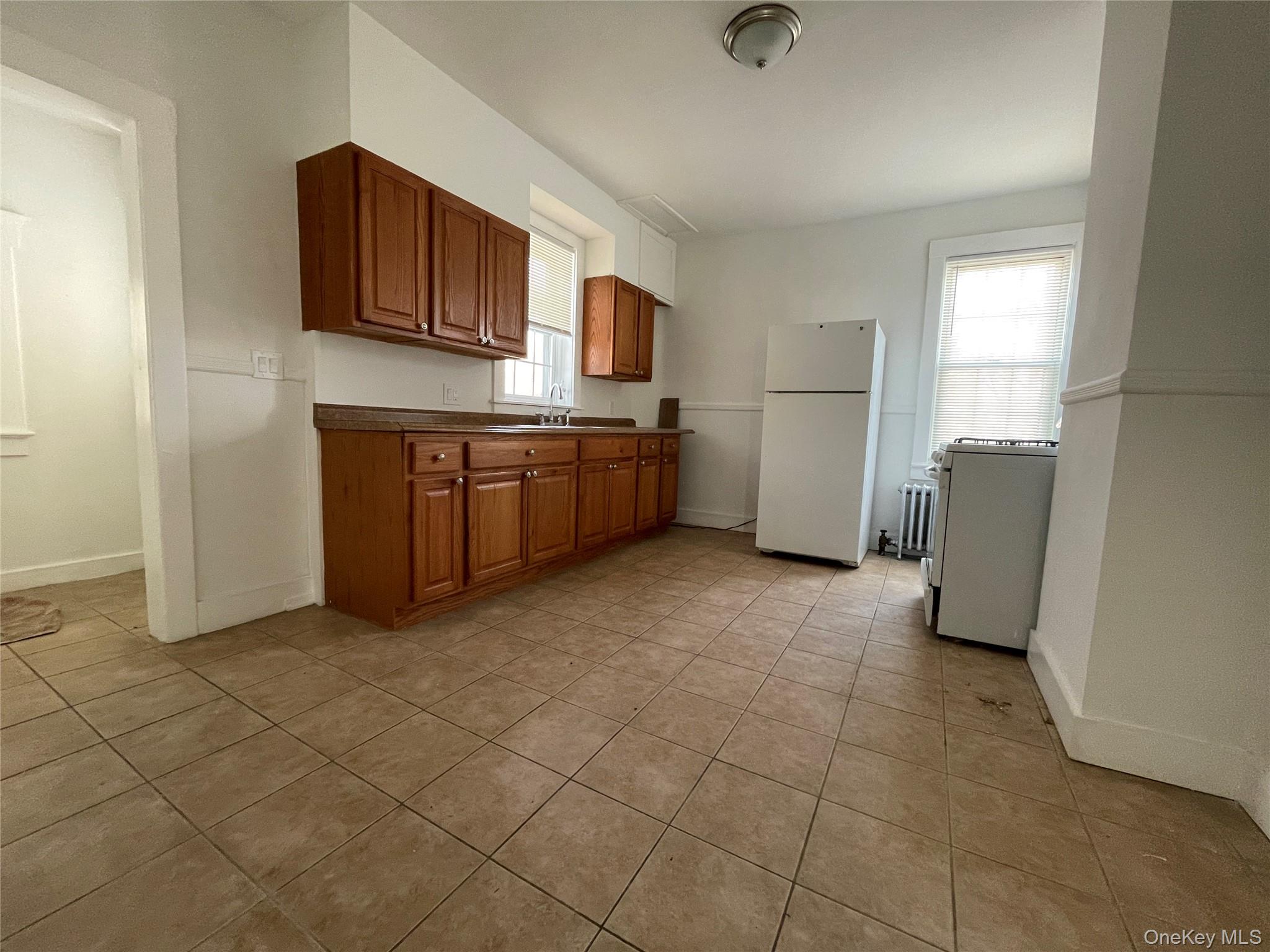 502 West Nyack Road, Unit 1 West Nyack, NY 10994 - Photo 6 of 12 a kitchen with stainless steel appliances granite countertop a refrigerator and a stove top oven
