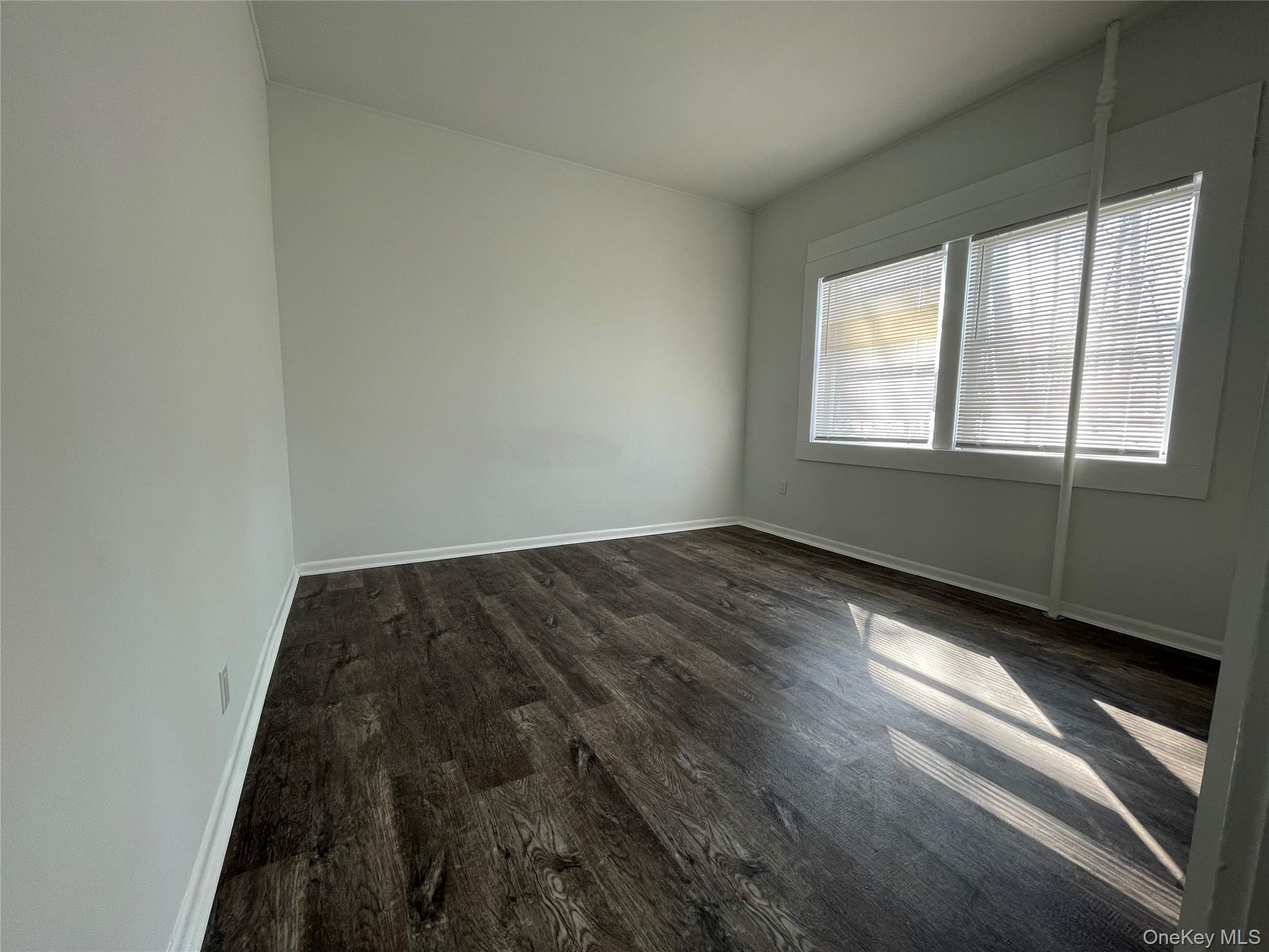 502 West Nyack Road, Unit 1 West Nyack, NY 10994 - Photo 8 of 12 an empty room with wooden floor and windows