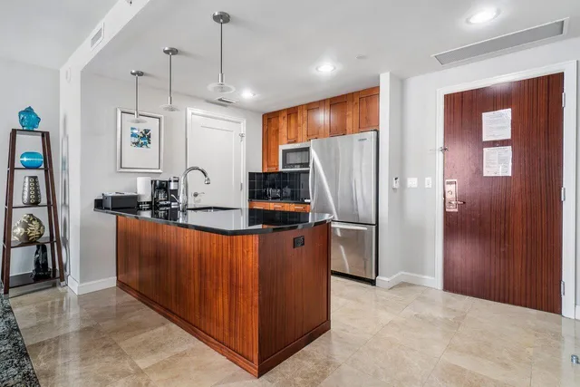 a kitchen with stainless steel appliances granite countertop a refrigerator and a stove