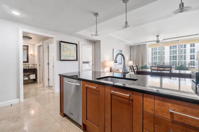 a kitchen with stainless steel appliances granite countertop a sink and wooden cabinets