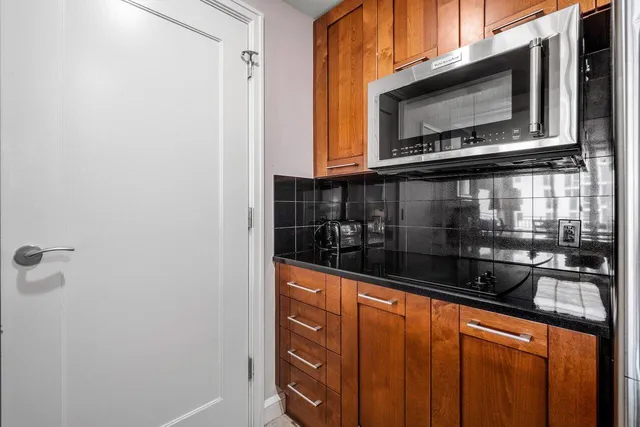 a kitchen with stainless steel appliances a microwave and a sink