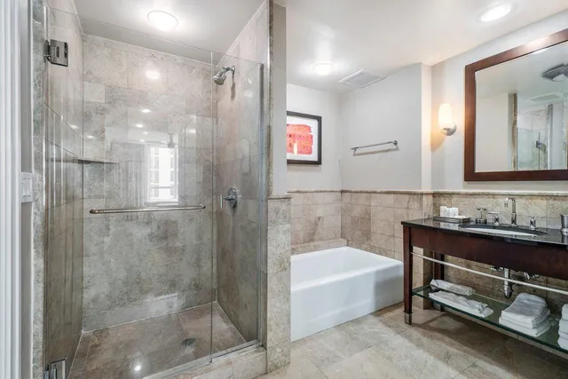 a bathroom with a bathtub and a shower