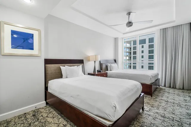 a bedroom with bed and large window